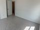 Clean bedroom featuring neutral walls, flooring covered in protective wrap, and a doorway to an adjacent room at 2113 Boxwood Se Cir, Conyers, GA 30094