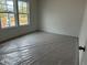Bedroom features a large windows, newly installed carpet with protective plastic at 2113 Boxwood Se Cir, Conyers, GA 30094