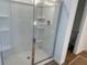 Modern shower stall featuring built in shelving and clear glass doors at 2113 Boxwood Se Cir, Conyers, GA 30094
