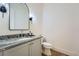 Modern powder bath with decorative mirror and granite counters at 8 Bass Se St, Atlanta, GA 30315