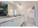 Bright bathroom featuring a double vanity with marble countertop and modern fixtures, plus a walk-in closet at 8 Bass Se St, Atlanta, GA 30315