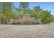 Beautiful stone wall and fountain at the community entrance, surrounded by mature trees at 8 Bass Se St, Atlanta, GA 30315