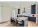 Stunning kitchen with navy cabinets, a spacious island, and stainless steel appliances at 8 Bass Se St, Atlanta, GA 30315