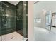 Modern shower with sleek green tiling and glass door, complemented by a view into a light-filled room at 8 Bass Se St, Atlanta, GA 30315