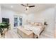 A bright main bedroom features light wood flooring, patterned wallpaper, and outdoor access through double doors at 1506 Avon Sw Ave, Atlanta, GA 30311