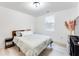 Bedroom features a queen bed, minimalist nightstand and modern decor accents at 1506 Avon Sw Ave, Atlanta, GA 30311