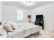 Bedroom features a cozy queen bed, a black bookshelf, and light hardwood floors at 1506 Avon Sw Ave, Atlanta, GA 30311