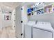 Laundry room with washer, dryer, and storage shelving in a hallway setting at 1506 Avon Sw Ave, Atlanta, GA 30311