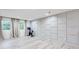 Workout room with Peloton bike, light hardwood floors, and modern wall paneling at 1506 Avon Sw Ave, Atlanta, GA 30311