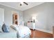 Bright bedroom featuring hardwood floors, white dresser, and ensuite bathroom at 3635 E Paces Ne Cir # 1308, Atlanta, GA 30326