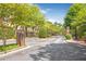 Elegant entrance gate with brick columns and mature trees on a paved road at 3635 E Paces Ne Cir # 1308, Atlanta, GA 30326
