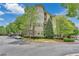 Beautiful condominium building with manicured landscaping and a circular driveway entrance at 3635 E Paces Ne Cir # 1308, Atlanta, GA 30326