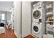 Convenient laundry room with stacked washer and dryer, along with shelving for organized storage at 3635 E Paces Ne Cir # 1308, Atlanta, GA 30326