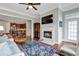 Comfortable living room with a fireplace, TV, hardwood floors, and open access to the kitchen at 3635 E Paces Ne Cir # 1308, Atlanta, GA 30326