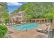 Community pool featuring lounge chairs, pergola, and manicured landscaping at 3635 E Paces Ne Cir # 1308, Atlanta, GA 30326