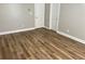 Bedroom with freshly painted gray walls, laminate flooring and two entry doors at 3923 High Dove Sw Way # 16, Smyrna, GA 30082