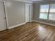 Bright bedroom features laminate flooring, neutral walls, and a large window with natural light at 3923 High Dove Sw Way # 16, Smyrna, GA 30082
