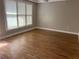 Sunlit bedroom featuring refinished hardwood flooring, natural lighting, and neutral walls at 3923 High Dove Sw Way # 16, Smyrna, GA 30082