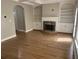 Inviting living room features a fireplace, built-in bookshelves, and hardwood floors at 3923 High Dove Sw Way # 16, Smyrna, GA 30082