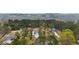 Scenic aerial shot of the property and neighborhood surrounded by lush trees and greenery at 4025 Bullock Bridge Rd, Loganville, GA 30052