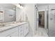 Bright bathroom features double sinks with granite counters, a glass shower, and a walk-in closet with a sliding glass door at 4025 Bullock Bridge Rd, Loganville, GA 30052