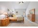 Comfortable bedroom featuring light gray walls, neutral carpet, and a wood bed frame with matching nightstand and dresser at 4025 Bullock Bridge Rd, Loganville, GA 30052