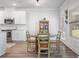 Cozy dining area features white cabinets, stainless appliances, wood-look floors, and a view of the backyard at 4025 Bullock Bridge Rd, Loganville, GA 30052
