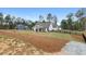 Beautiful white farmhouse-style home featuring a covered patio and surrounded by a black fence at 4025 Bullock Bridge Rd, Loganville, GA 30052