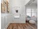 Inviting foyer features decorative wainscoting, wood-look floors, and a charming front door with a window at 4025 Bullock Bridge Rd, Loganville, GA 30052