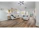 Bright living room featuring wood-look floors, vaulted ceilings, neutral paint, and an open floor plan at 4025 Bullock Bridge Rd, Loganville, GA 30052