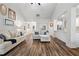 Inviting living room showcases wood-look floors, neutral decor, an open layout, and great natural light at 4025 Bullock Bridge Rd, Loganville, GA 30052