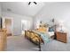 Large primary bedroom featuring high ceilings, plush carpet, and ample natural light at 4025 Bullock Bridge Rd, Loganville, GA 30052