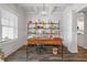 Bright home office featuring custom shelving, coffered ceilings, wood-look floors and plenty of natural light at 4025 Bullock Bridge Rd, Loganville, GA 30052