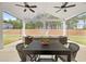 Inviting outdoor patio with an expansive view, comfortable seating, dining area, and ceiling fans for relaxation at 4025 Bullock Bridge Rd, Loganville, GA 30052