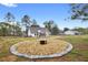 Backyard features a circular fire pit area with decorative rocks and brick trim at 4025 Bullock Bridge Rd, Loganville, GA 30052