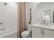 Bathroom featuring a shower and tub combination, sink with modern faucet, and decorative curtain and wall hanging at 1770 Beckham Ne Pl # 47, Atlanta, GA 30324