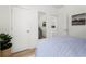 Cozy bedroom showcasing a bed with blue comforter, adjacent to closet and bathroom doors at 1770 Beckham Ne Pl # 47, Atlanta, GA 30324
