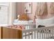 Bedroom with a crib, changing station, and decor, creating a soothing space for a baby at 1770 Beckham Ne Pl # 47, Atlanta, GA 30324