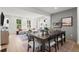 Dining room with gray accent wall opens to a living room filled with natural light at 1770 Beckham Ne Pl # 47, Atlanta, GA 30324