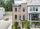 Charming brick townhouse with black framed windows, a balcony, and a landscaped front yard at 1770 Beckham Ne Pl # 47, Atlanta, GA 30324