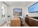 Bright home office with a wooden desk, neutral chairs, and a flat screen tv on the wall at 1770 Beckham Ne Pl # 47, Atlanta, GA 30324