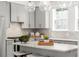 Modern kitchen island with gray cabinets, stone countertops, and stainless steel appliances at 1770 Beckham Ne Pl # 47, Atlanta, GA 30324
