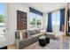 Living room with a large sectional sofa, neutral walls, blue curtains, and a modern art piece, creating a cozy space at 1770 Beckham Ne Pl # 47, Atlanta, GA 30324
