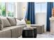 Living room with a large sectional sofa, neutral walls, blue curtains, and a modern art piece, creating a cozy space at 1770 Beckham Ne Pl # 47, Atlanta, GA 30324