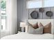 Close up of main bedroom with board and batten accent wall with decorative woven basket wall hangings at 1770 Beckham Ne Pl # 47, Atlanta, GA 30324