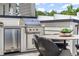 Outdoor kitchen featuring stainless steel Coyote grill and fridge built into modern cabinets at 1770 Beckham Ne Pl # 47, Atlanta, GA 30324