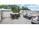 Relaxing rooftop deck featuring an outdoor dining table, lounge furniture, and privacy fencing at 1770 Beckham Ne Pl # 47, Atlanta, GA 30324