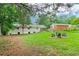 Spacious backyard featuring green lawn and an outdoor seating area with Adirondack chairs at 679 Forest Ridge Se Dr, Marietta, GA 30067