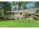 Spacious backyard with lush green grass, fenced in area, and back porch at 679 Forest Ridge Se Dr, Marietta, GA 30067