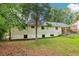 Large backyard showing ample green space, tree coverage, and the exterior of the home at 679 Forest Ridge Se Dr, Marietta, GA 30067